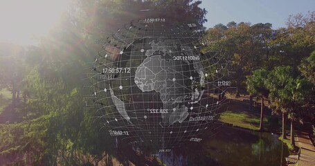 Displaying holographic globe overlaying pond and walkway in urban park, showing data points