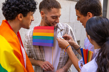 Friends celebrating pride day with rainbow flag