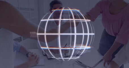 Shaking hands colleagues reviewing documents in office, with holographic globe and office supplies