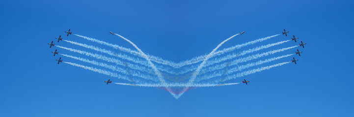 aircrafts aerobatic group drawing Spanish flag figure in the blue sky