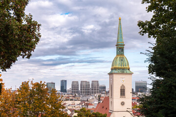 St. Martin’s Cathedral in Bratislava, Slovakia, with modern skyscrapers in the background – contrast of history and contemporary city.