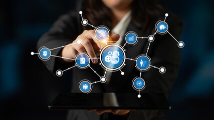 A business professional engages with a futuristic technology interface showcasing holographic icons related to connectivity and innovation, enhancing workplace efficiency. Tessel