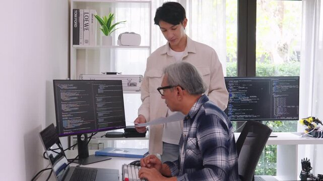 Group of asian senior in a collaborative software development analyzing  flowcharts  during a bootcamp training
