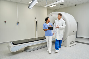 Fototapeta premium Doctors collaborate in advanced hospital setting to analyze MRI scan results