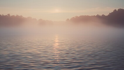 Obraz premium Reflecting misty lake surface capturing pale dawn glow at forested shoreline, with sun reflection