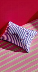 Striped pillow with mask against colorful background
