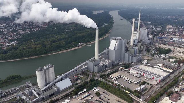 Grosskraftwerk Mannheim Aktiengesellschaft, energy production. Electricity from coals. Along the rhine river in Germany. Aerial video.