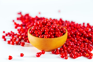 Ripe shiny lingonberries on white background.