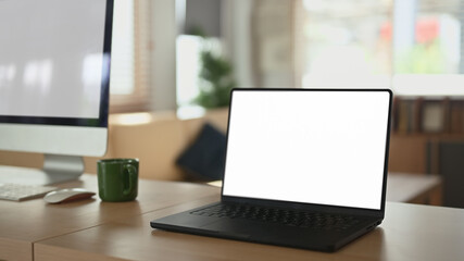 Naklejka na ściany i meble Empty screen laptop computer on table at home office Naklejka na ściany i meble Empty screen laptop computer on table at home office