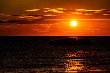 Intense Orange Sunset with Dark Sea and Sun Disc