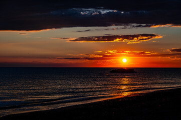 Deep Red and Orange Sunset Silhouette Over the Ocean