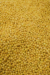 A mass of small, round, yellow pellets.