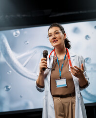 woman is giving a presentation at a conference