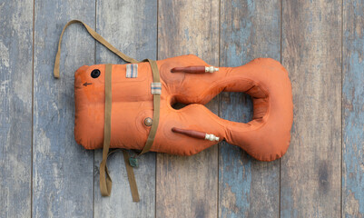 orange life jacket on wooden background