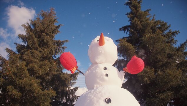 Standing three-tiered snowman wearing twig-arms in park, with button eyes, carrot nose, red mittens