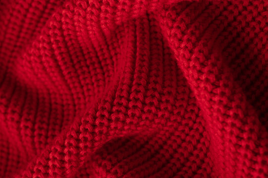 Knitted red background. Close-up. Cozy concept