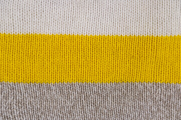 Striped texture of the knitted background. Abstract texture, handmade from knitted fabric. Background and texture for design