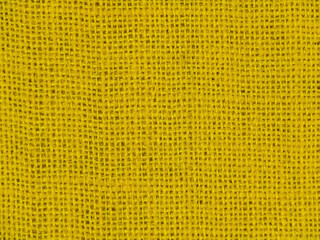 A jute bag with a natural burlap texture, painted yellow.