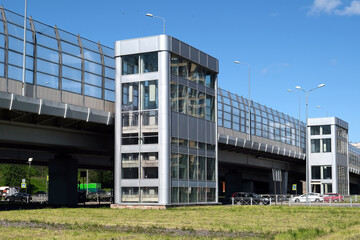 The Modern Elevators at the Urban Overpass Stand Out Against the Clear Blue Sky Above