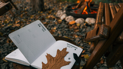 Autumnal scene with a diary open to October 31st and November 1st