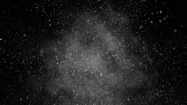 Mesmerizing display of white particles floating against dark background creates depth and movement, evoking tranquility and wonder reminiscent of snow, while dynamic bursts enhance energy