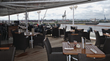 Guest pooldeck or swimmingpool with sun deck on modern family cruiseship or cruise ship liner with elegant lounge furniture deck chairs and rattan sun beds loungers