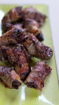 Grilled beef rolls cooking on hot pan, juicy and smoky with herbs and spices. Street food style barbecue perfect for food videos, recipe blogs, and culinary content. High quality 4k footage