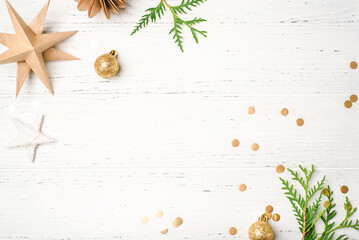 Festive Christmas background with Christmas decorations on white wooden table. Top view. Copy space for text.
