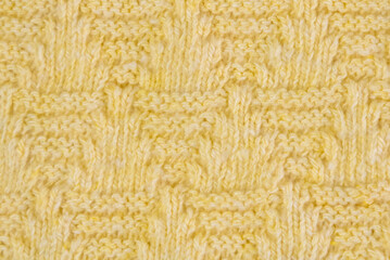 Yellow knitted fabric with large patterns, textured background