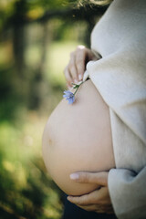 pregnant woman holding flower