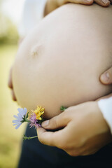 pregnant woman holding flower
