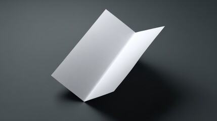 Minimalist white brochure standing on a dark surface, showcasing a modern design with clean lines and soft shadows.