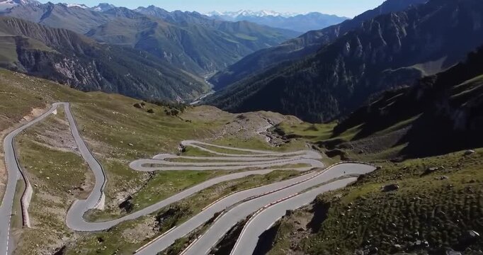 mountain road with numerous hairpin turns carved into a steep, green hillside, overlooking a deep valley.