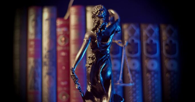  Lady Justice Sculpture with Law books behind