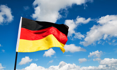 German flag waving against blue sky