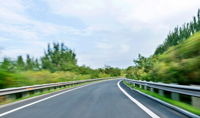 Fototapeta premium Empty curved road in motion blur