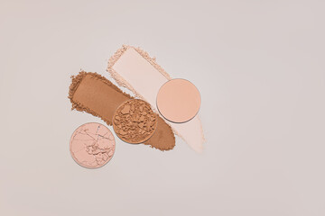 Two gorgeous strokes, samples of different tones of compact powder and three blocks of powder on a...