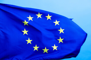 European Union Flag waving on blue background