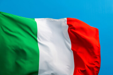 Fototapeta premium Italian flag waving on blue background