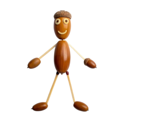 A whimsical figure made from various natural materials, featuring a smiling face and a playful stance.