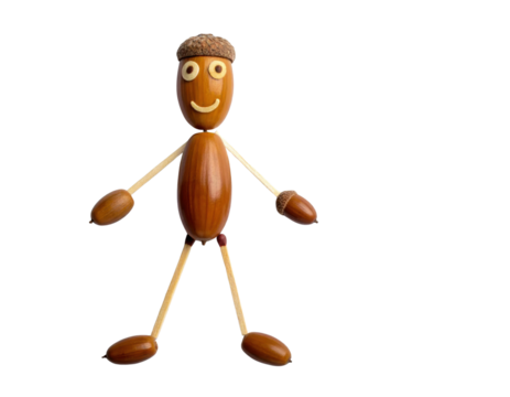 A whimsical figure made from various natural materials, featuring a smiling face and a playful stance.