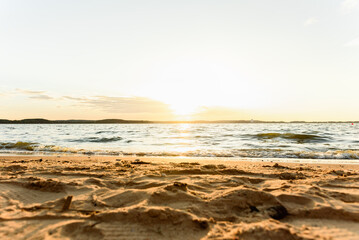Sandy beautiful beach, calm sea surface and very small waves.