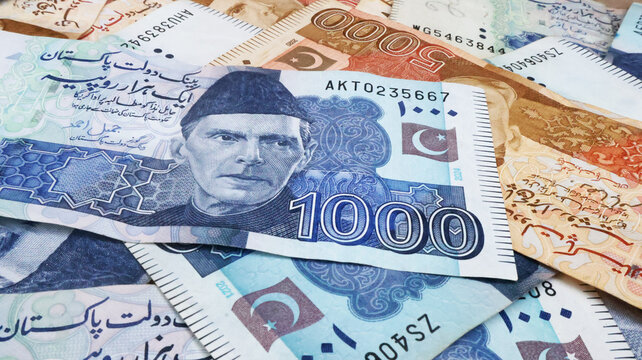 Pakistani paper money of different values placed together, symbolizing finance, economy, savings, and investment in Pakistan. featuring Quaid-e-Azam Muhammad Ali Jinnah portrait and security features.