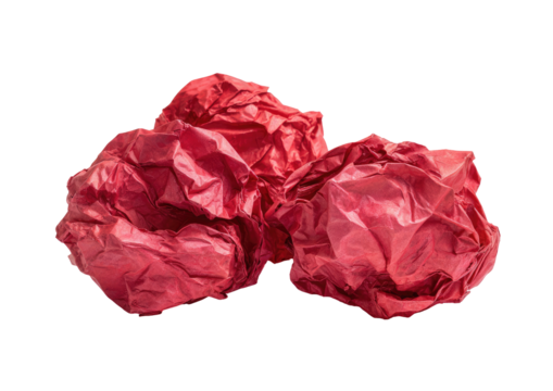 Crumpled, shiny, red paper balls on a solid black background