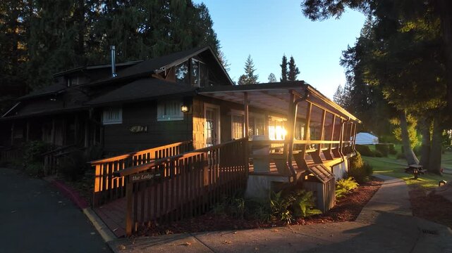 4K smooth autumn footage of a lakeside lodge at Quinault Lake in Olympic National Forest, USA, under warm sunset light in fall season, perfect for vacation, tourism, and weekend getaways for visitors