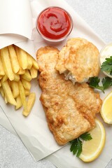British Traditional Fish and chips served with sauces on light grey table, flat lay