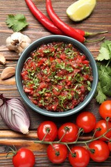 Tasty salsa sauce and ingredients on wooden table, flat lay