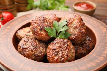 Delicious meat patties with parsley and sauce on table, closeup