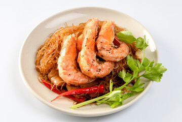 Baked shrimp with glass noodles in a plate on a white background