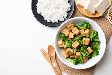 Stir fried tofu and broccoli with soy sauce eating with cooked rice, Asian vegan food, Top view